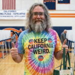 California man standing inside of a voting polling station.