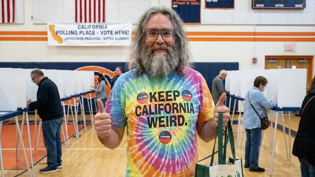 California man standing inside of a voting polling station.