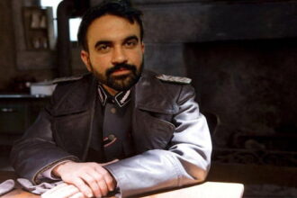 New York City Mayor Mamdani sitting at a table inside of a home.