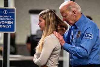 Joe Biden wearing a TSA uniform groping a woman in an airport terminal.
