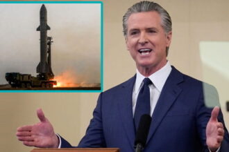 California Governor Gavin Newsom giving a speech behind a podium on Iran.