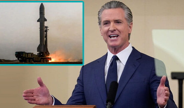 California Governor Gavin Newsom giving a speech behind a podium on Iran.