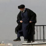 Iran Ayatollah wearing Islamic clothing standing on a rooftop in Iran.