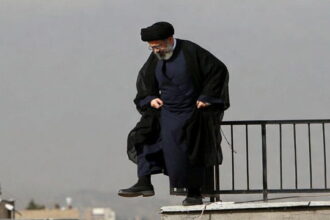 Iran Ayatollah wearing Islamic clothing standing on a rooftop in Iran.