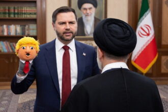 JD Vance wearing a suit and using a Donald Trump sock puppet on his hand talking to an Iran leader.