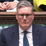 UK Prime Minister Keir Starmer sitting in Parliament at a seat.