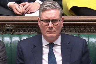 UK Prime Minister Keir Starmer sitting in Parliament at a seat.