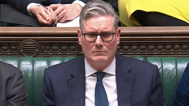 UK Prime Minister Keir Starmer sitting in Parliament at a seat.