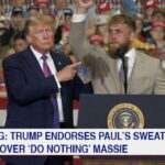 Donald Trump on stage with boxer Jake Paul during a rally.