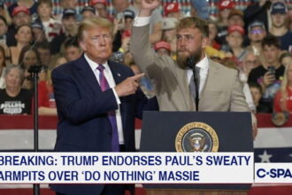 Donald Trump on stage with boxer Jake Paul during a rally.
