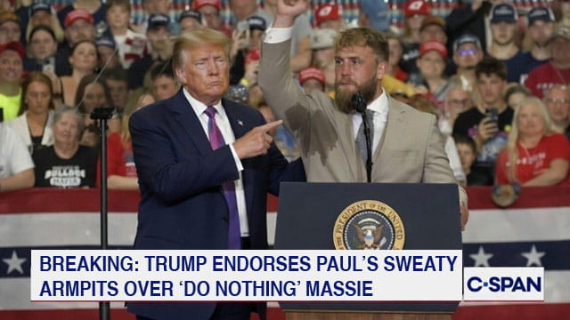 Donald Trump on stage with boxer Jake Paul during a rally.