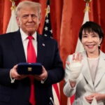 Japan Prime Minister standing with President Donald Trump in White House.