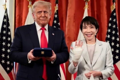 Japan Prime Minister standing with President Donald Trump in White House.