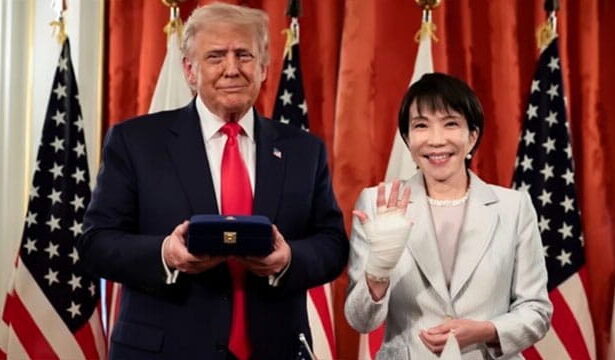 Japan Prime Minister standing with President Donald Trump in White House.