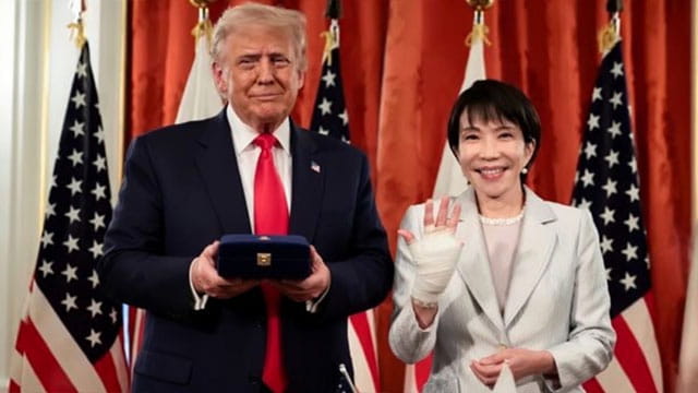 Japan Prime Minister standing with President Donald Trump in White House.