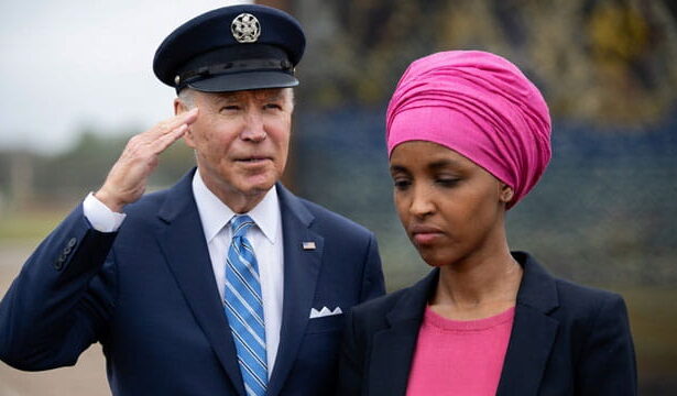 Joe Biden saluting Ilhan Omar outside during a speech.