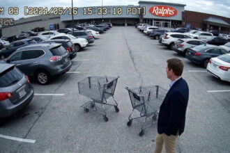 Video of Democrat Eric Swalwell wearing suit pushing shopping cart in parking lot.