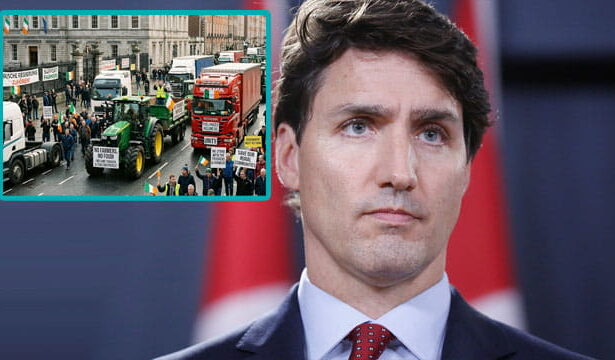 Justin Trudeau standing in front of an image of the Irish trucker protest.