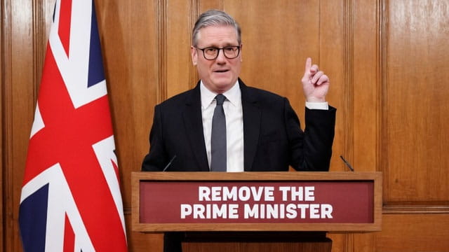 UK Prime Minister Keir Starmer giving a speech behind a podium.