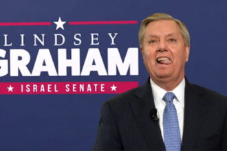 Lindsey Graham wearing a suit standing in front of a campaign sign with the words "Israel Senate."