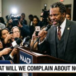 NAACP black man wearing suit giving speech on SPLC indictment.