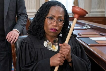 Black female US Supreme Court Justice Ketanji Brown Jackson holding a plumber's plunger.