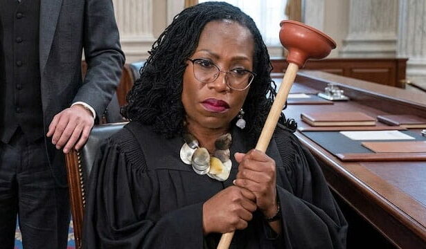 Black female US Supreme Court Justice Ketanji Brown Jackson holding a plumber's plunger.