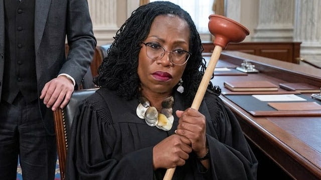 Black female US Supreme Court Justice Ketanji Brown Jackson holding a plumber's plunger.