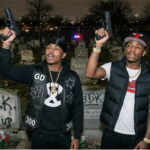 Black Chicago gang members holding up guns inside of a graveyard on Memorial Day.
