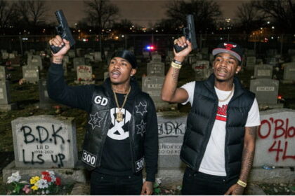 Black Chicago gang members holding up guns inside of a graveyard on Memorial Day.