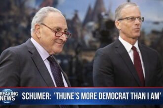 Congress members Chuck Schumer and John Thune giving interview in Senate building.