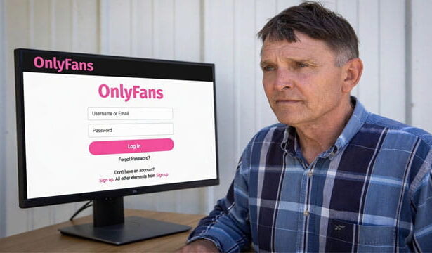 Ed Gallrein sitting at a desk looking at a computer screen on the OnlyFans website.