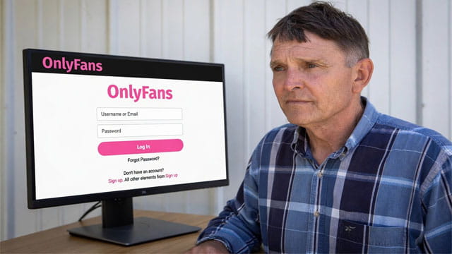 Ed Gallrein sitting at a desk looking at a computer screen on the OnlyFans website.