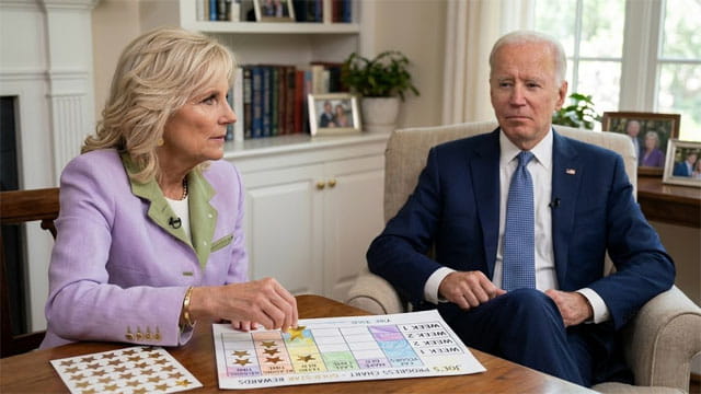 Jill Biden and Joe Biden sitting at home in a living room.