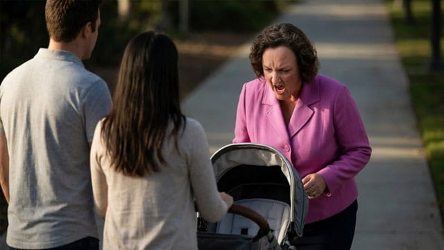 California Democrat Katie Porter looking down at a baby stroller and yelling.