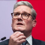 UK Labour Party Prime Minister Keir Starmer rubbing his chin.