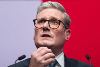 UK Labour Party Prime Minister Keir Starmer rubbing his chin.