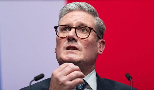 UK Labour Party Prime Minister Keir Starmer rubbing his chin.