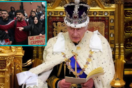 UK King Charles sitting on a throne giving a speech.