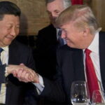 President Trump and President Xi shaking hands on stage in China Summit.