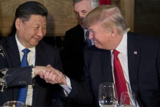 President Trump and President Xi shaking hands on stage in China Summit.