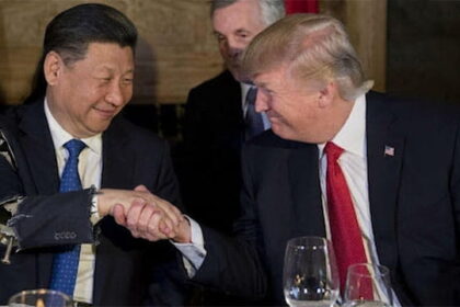 President Trump and President Xi shaking hands on stage in China Summit.