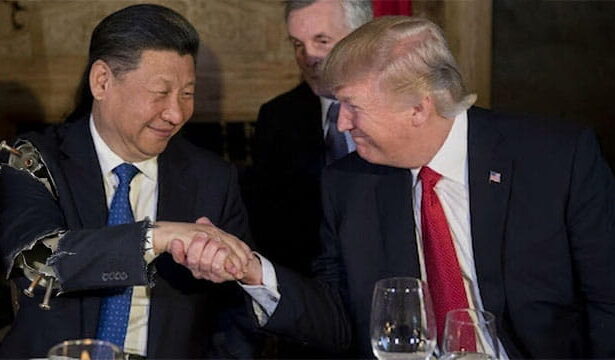 President Trump and President Xi shaking hands on stage in China Summit.
