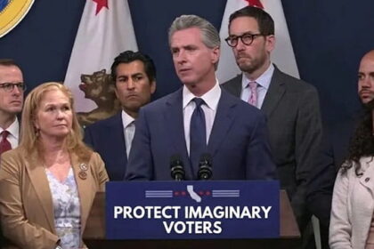 California Democrats and Gavin Newsom on stage giving a speech.