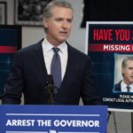 Gavin Newsom standing in front of a podium speaking on California fraud.