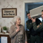 German police raiding a grandmother's home and confiscating her air conditioner.