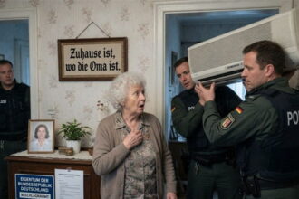 German police raiding a grandmother's home and confiscating her air conditioner.