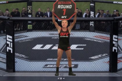 Lindsey Graham wearing a Octagon Girl uniform holding up a sign at Trump's UFC Freedom Event.