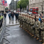 US military troops guarding British citizens in the UK street against Met police.