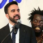 NYC Mayor Zohran Mamdani giving a speech on stage in front of a Haitian migrant.
